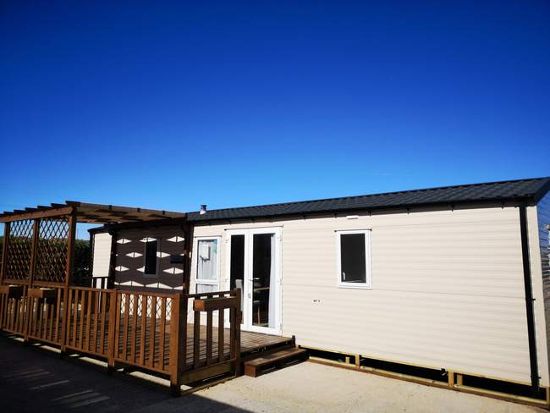 Outside of the luxury home, with decking : 2 bed, 2 bath mobile home for sale in Los Carrascos